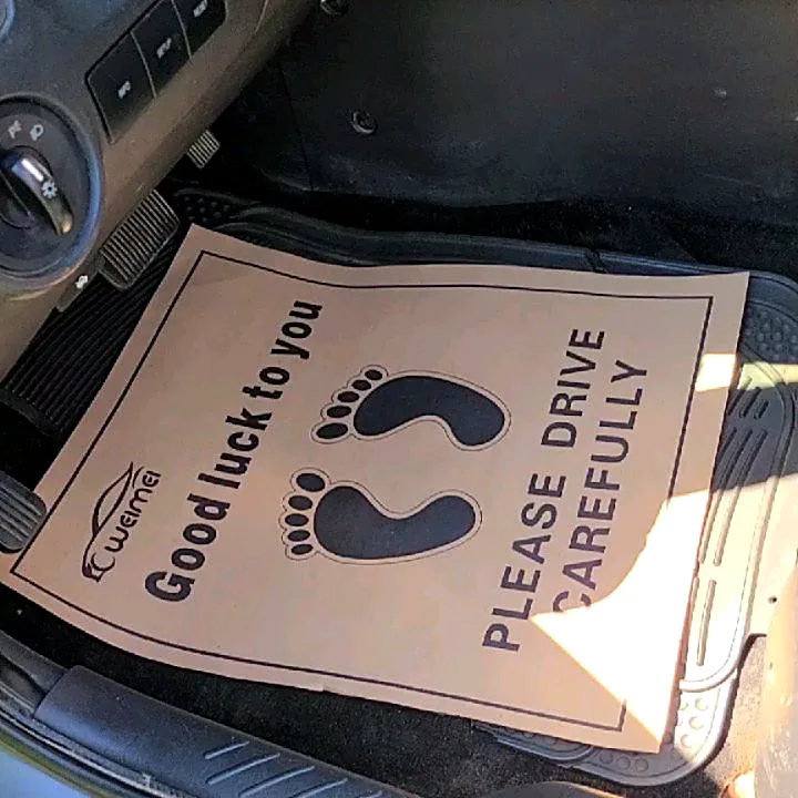 Paper floor mat reading Good luck to you, please drive carefully